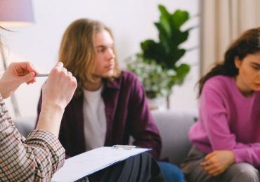 Sad couple signing divorce papers