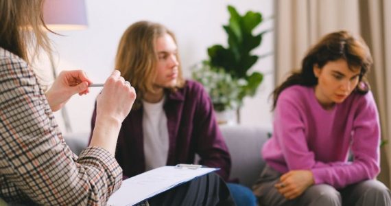 Sad couple signing divorce papers